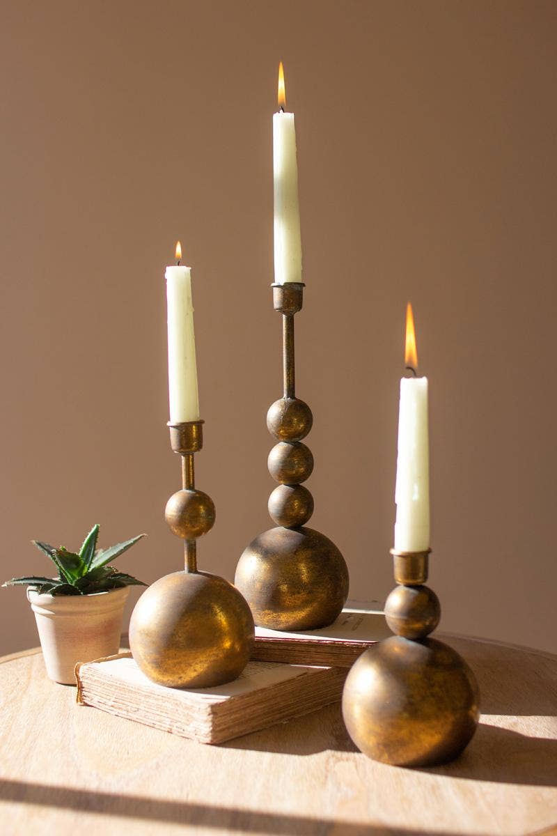 SET OF THREE ANTIQUE BRASS TAPER CANDLE HOLDERS: Gold / Metal / Large: 4"d x 11.5"t; Medium: 4"d x 8.5"t; Small: 4"d x 6.5"t