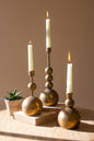 SET OF THREE ANTIQUE BRASS TAPER CANDLE HOLDERS: Gold / Metal / Large: 4"d x 11.5"t; Medium: 4"d x 8.5"t; Small: 4"d x 6.5"t