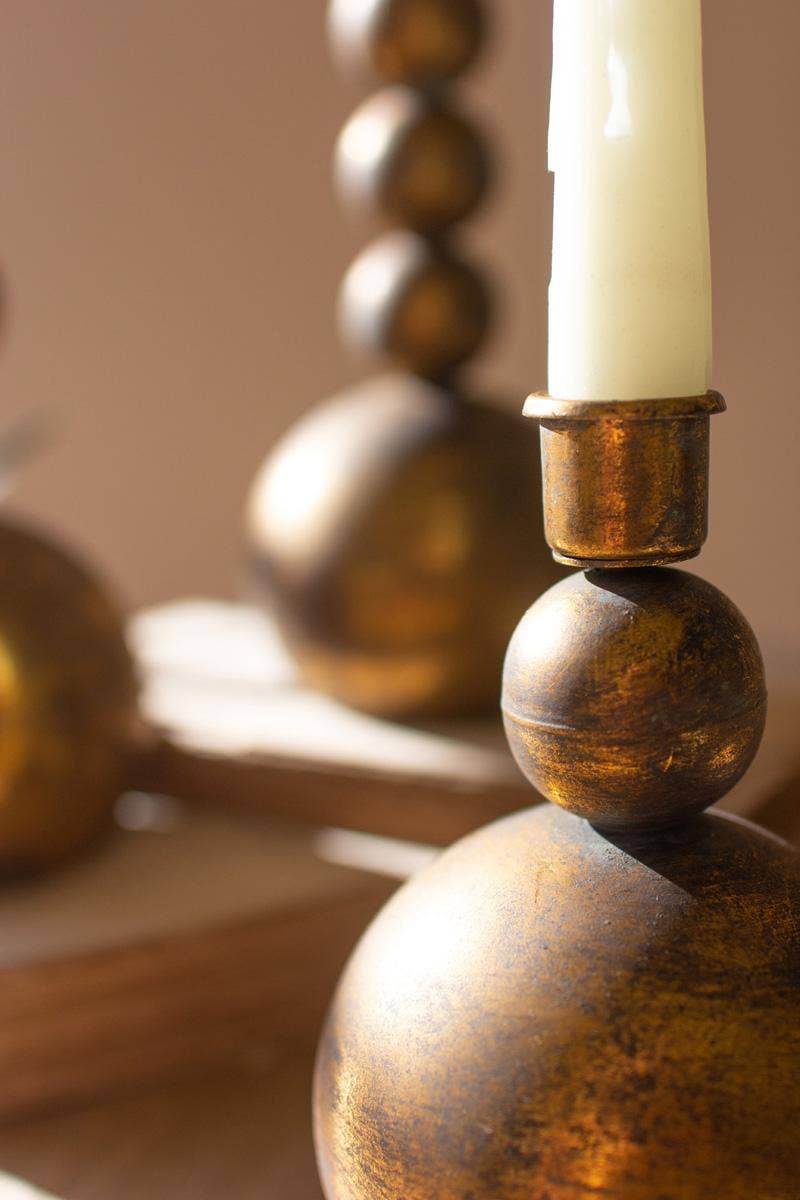 SET OF THREE ANTIQUE BRASS TAPER CANDLE HOLDERS: Gold / Metal / Large: 4"d x 11.5"t; Medium: 4"d x 8.5"t; Small: 4"d x 6.5"t